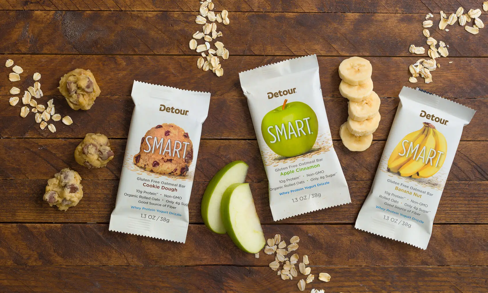 Detour protein bar brand product photography style, featuring Smart protein bar flavors of chocolate chip, apple cinnamon and banana nut.