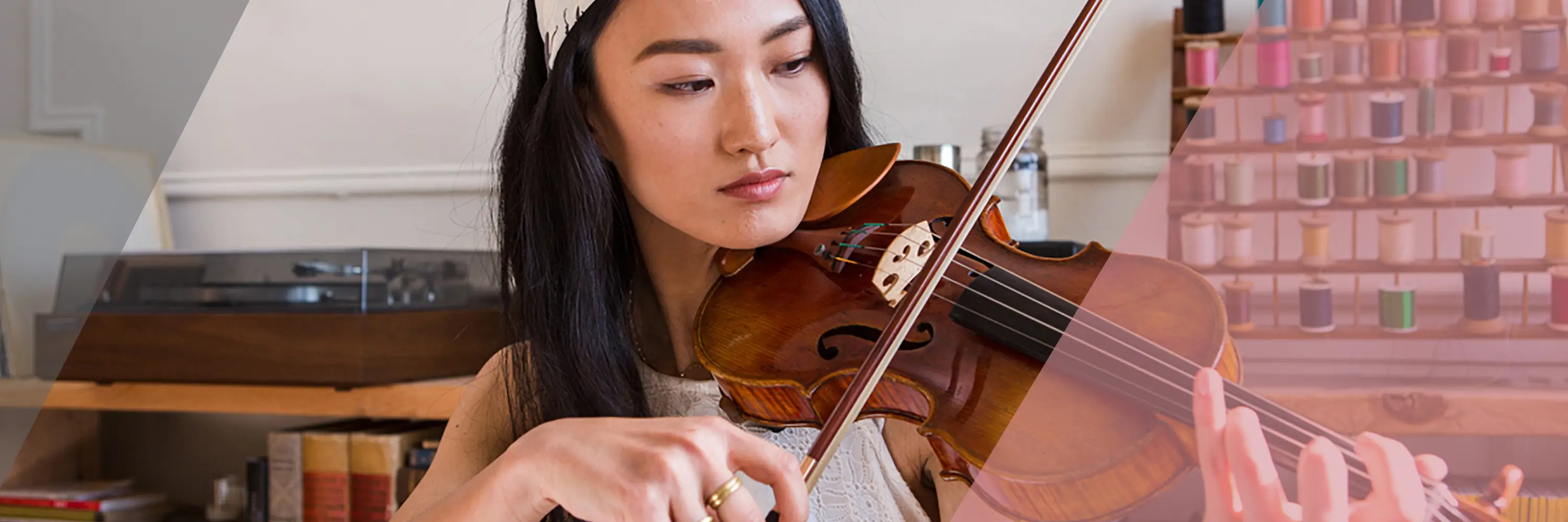 Woman playing violin for Adobe demo application asset.