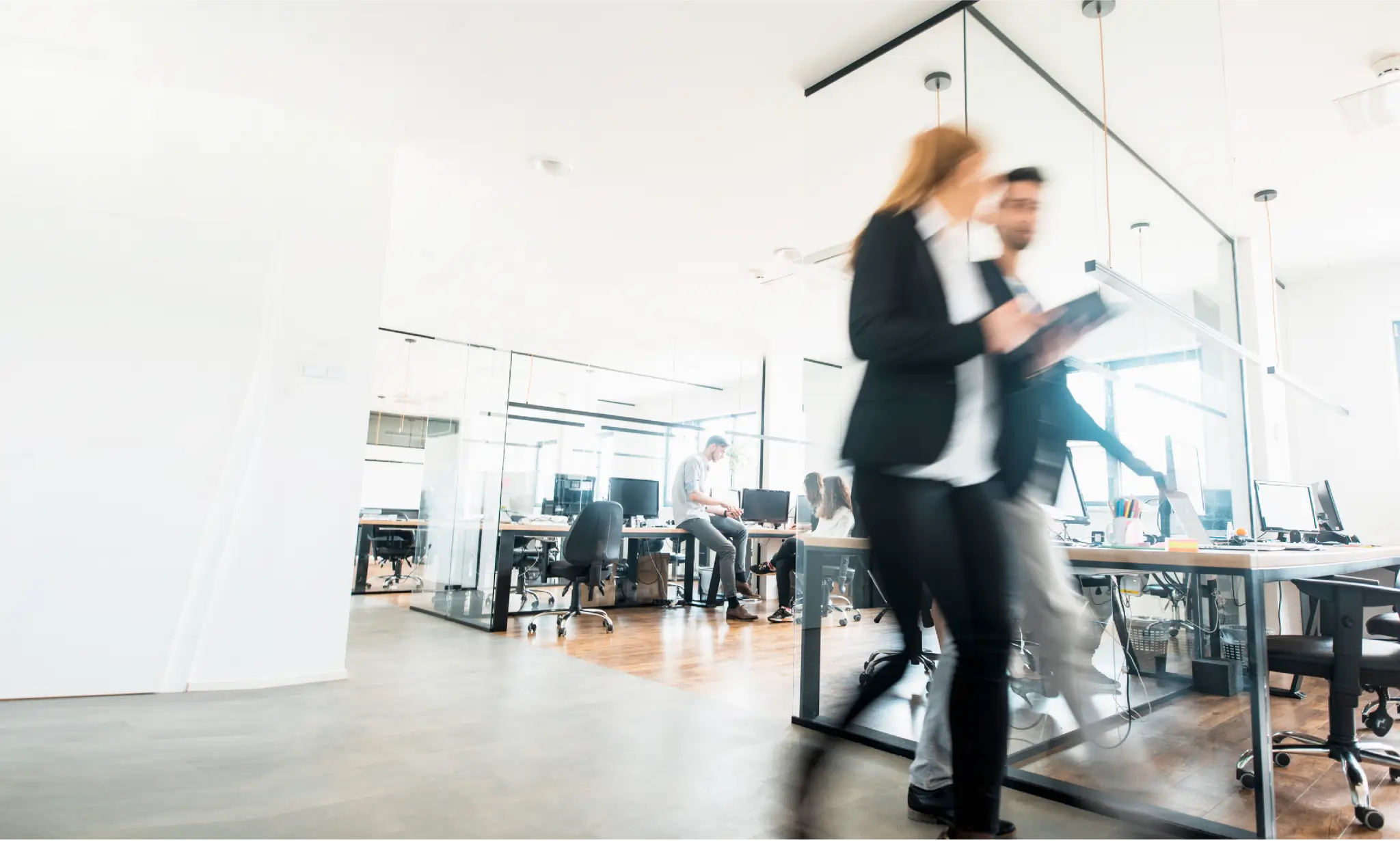 SpaceIQ brand photography style, two people walking in an open office.