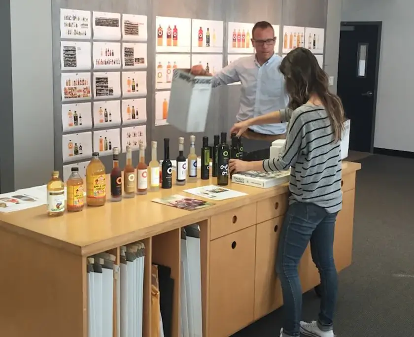 Office crit wall with O Olive Oil