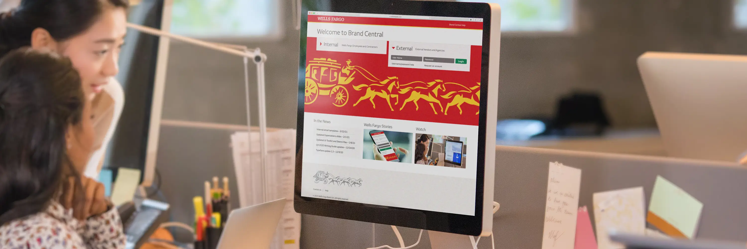 Women viewing the Wells Fargo Brand Central website on a desktop computer.